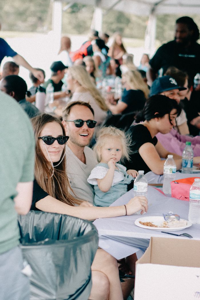 A happy family enjoying a sunny outdoor community gathering in Clemson.